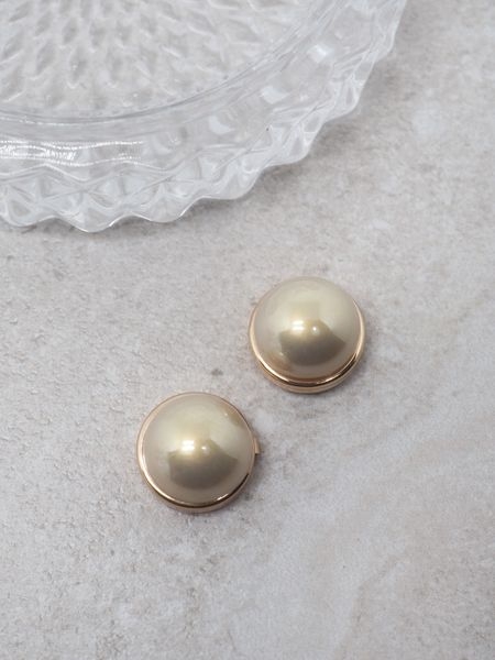 En tidløs detalj som gir antrekket et sofistikert preg! Denne gullfargede knappepynten med en klassisk beige perle passer perfekt til både hverdags- og festantrekk. Den nøytrale fargen gjør den enkel å kombinere med ulike plagg og stiler.